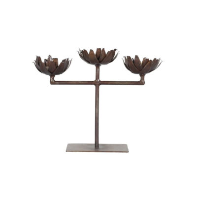 The 3-arm Indian vintage candelabra displayed on a dining table as a centrepiece.